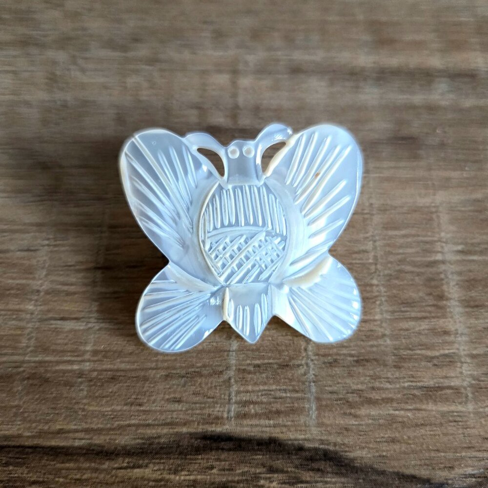 Carved mother of pearl butterfly brooch.